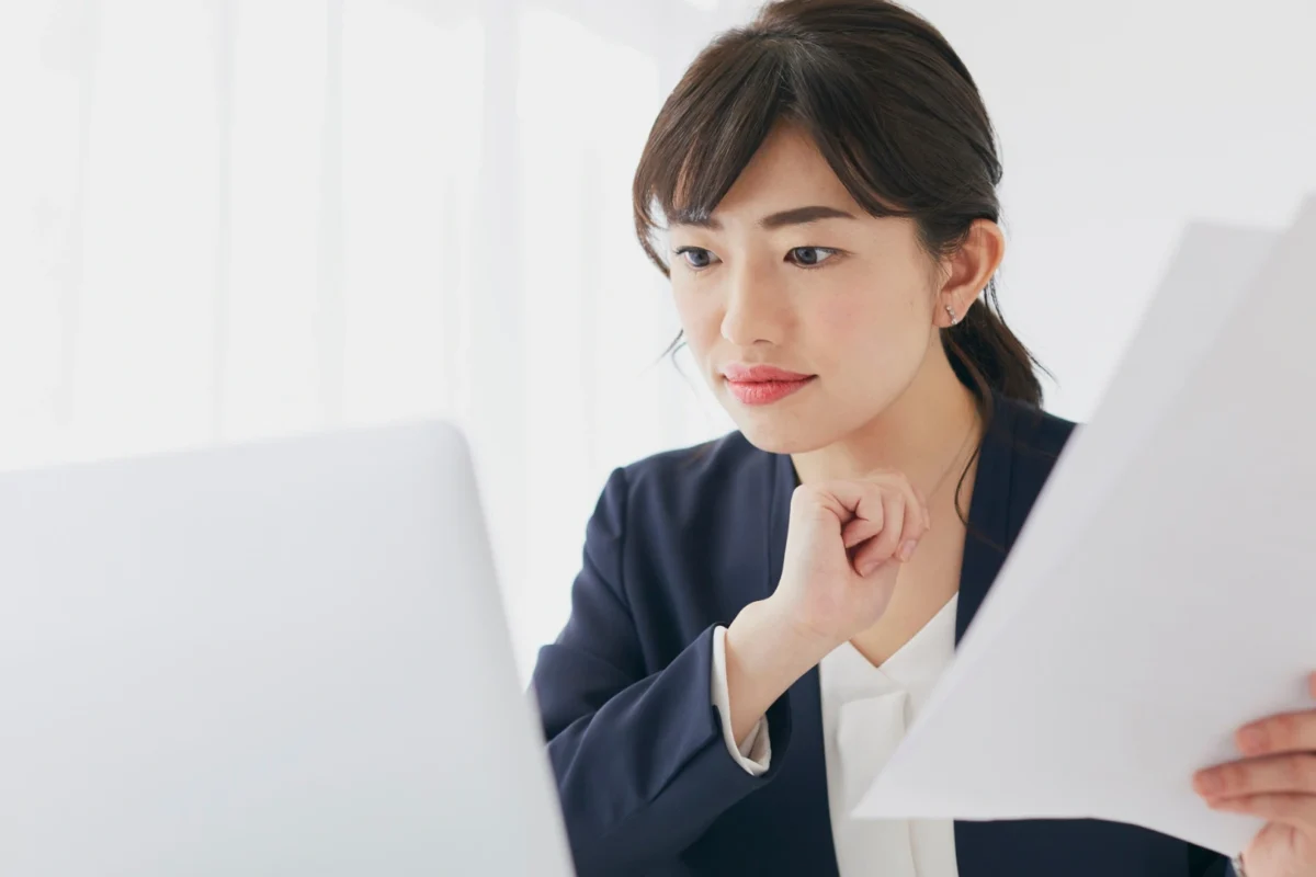Business professional reviewing international documents online, illustrating the use of e-Apostilles and digital authentication for global business.