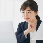 Business professional reviewing international documents online, illustrating the use of e-Apostilles and digital authentication for global business.