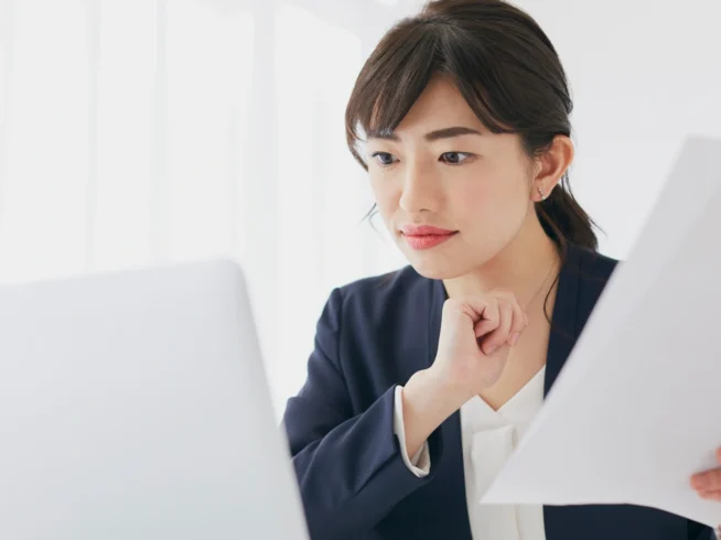 Business professional reviewing international documents online, illustrating the use of e-Apostilles and digital authentication for global business.