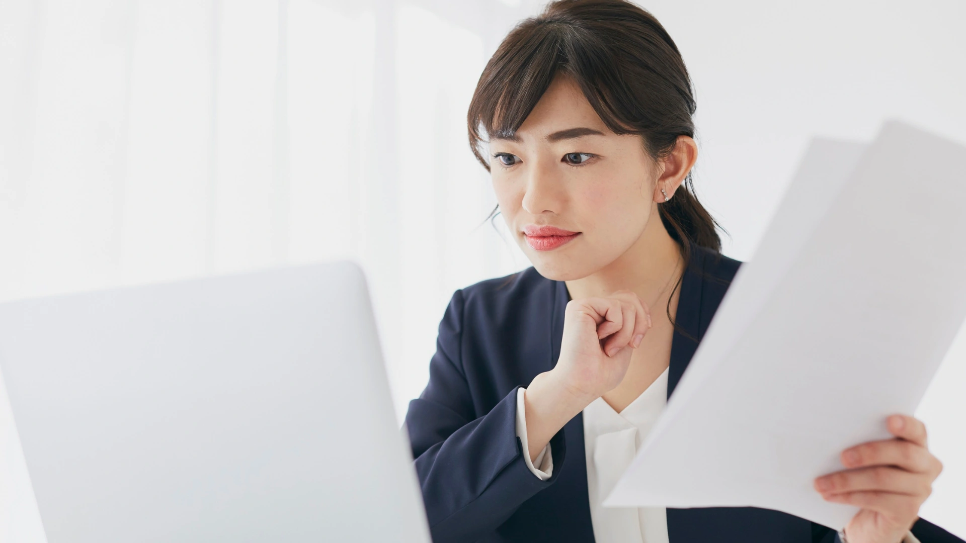 Business professional reviewing international documents online, illustrating the use of e-Apostilles and digital authentication for global business.